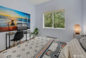 Spacious second bedroom comfortably fits a queen-size bed with room to spare for a home office desk—ideal for guests, remote work, or a peaceful retreat.