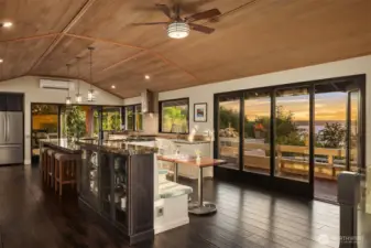 The kitchen opens onto the deck overlooking views and pool as well as on the south side towards the covered entertaining area.