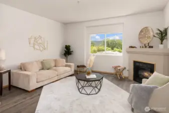 Bright living room with serene views of the valley and a cozy corner fireplace