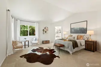 At the top of the stairs is the entrance to the primary bedroom, with vaulted ceilings and oodles of space to create your own indoor oasis.