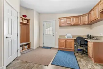 Multi-purpose/utility room w/nice shoe/coat rack area, closet, desk area & spot for fridge! Door leads to walk way from detached garage