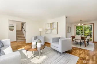 Glimpse at the unique side-oriented staircase & dining room from living area
