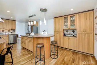 Eat-at counter areas + abundant cabinet storage areas & custom glass wine rack cabinet.