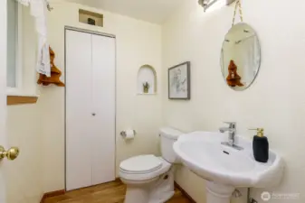 Spacious powder room w/ large pedestal sink & large closet area too