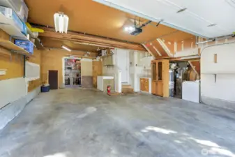 Large garage area can hold 2 cars deep on left side or shop/storage area. Rear shop room w/ skylight & backyard entry fits your hobby needs.