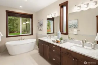 A spa like soaking tub overlooking the backyard