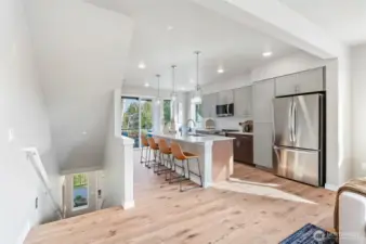 Luxury laminate flooring throughout the main level is standard.   Photo is of community model home and same plan.