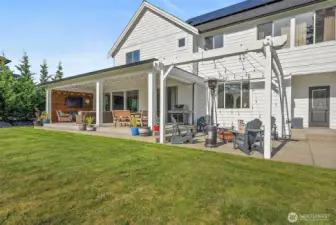 Outside covered patio for year round outdoor living. Turn on the tv, gather round the table or fire. Sit in the hot tub and enjoy all of this beauty.