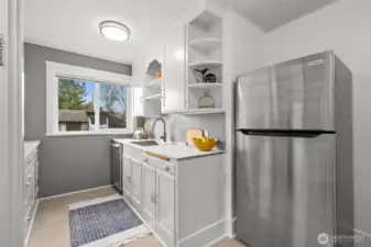 Those open corner shelves and the art deco cutout over the sink are pure personality, paired perfectly with a modern new sink and high-arch faucet. And yes… it’s a dishwasher, and yes… it’s just one year new, making this kitchen as functional as it is charming.