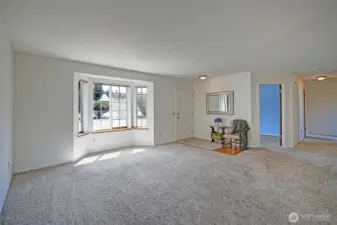 Great living room by the front door with newer carpet and lots of light.