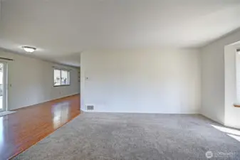 Living room opens up to additional great room spaces.