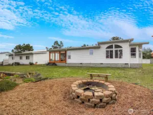 The backyard overlooks the lagoon, firepit, fish cleaning station, dock and more! Great location right outside of Surfside.