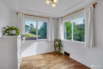 Abundant light pours through the dining room picture windows.