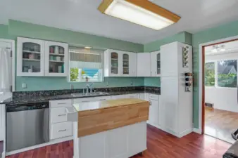 Glass display cabinets highlight the bright white cabinetry.