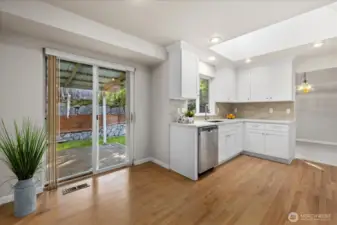 kitchen with skylight opens to the back patio & fully fenced backyard for entertaining!