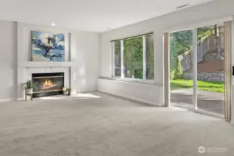 Downstairs family room w/wood fireplace opens to the back patio.