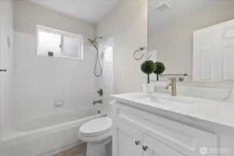 New bathroom vanity cabinets with new floors and toilet on the lower level.