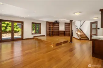Lower level great room with built in library style shelving.