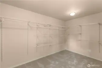 Generously sized master closet with shelves