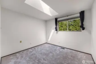 bedroom 2 with natural light from the skylight