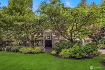 The lush yard showcases a rich variety of plantings, ornamental shrubs and mature trees. All-yard outdoor landscaping lighting by highly acclaimed Moonshadows Landscape Lighting, with lights in trees, up lighting, and lighting within the perimeters, creates a magical glow as soon as the sun goes down.