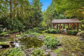 Flag stone grounds surround the water fountain; makes for the most peaceful setting you've ever experienced!  And at dusk, the landscaping is aglow in outdoor lighting, it's stunning.
