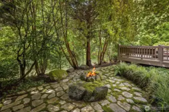 Also from the gazebo, looking back towards the hot tub area of the deck, you see the outdoor woodburning fire pit.  Elegant stone patios everywhere.  You simply must see.  Beyond the fence is a