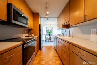 Nicely appointed kitchen with glass cooktop range, built in microwave and tons of cupboard space.