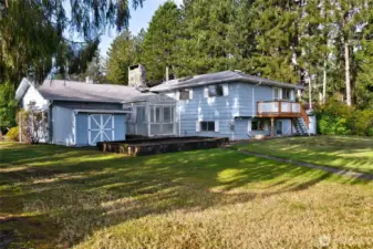 Backyard with raised garden beds and greenhouse.