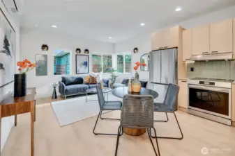 Main level open living and kitchen area with custom tile and lighting.