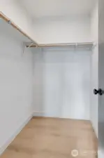 Top floor primary suite with a spacious walk-in closet.