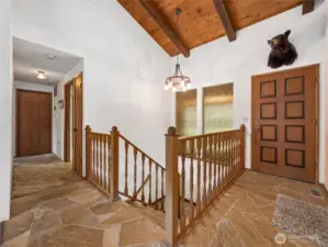 This is the entry area--complete with a real bear's head! See the beautiful ceramic flooring and warm wood touches throughout.