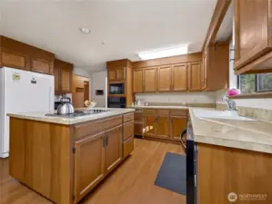 Note the extra large refrigerator and well-designed layout, including the stove on the island.