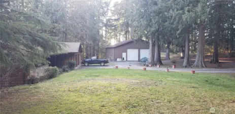 Here you can see the large semi-circular driveway, house on the left, and large detached garage/shop in the far section, with the front yard in the foreground.