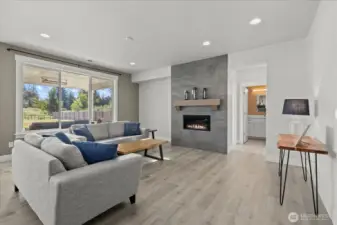 Main living area featuring fireplace and LVP.