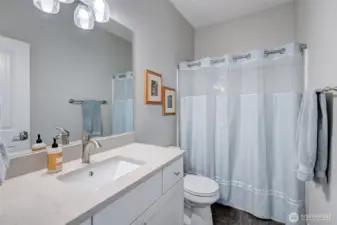 Stylish and spacious main bathroom with quartz counter and quality tub/shower combo.