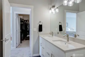 Primary bath sits right across the hall from the oversized walk-in closet.