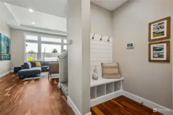 A charming and practical "drop zone", just off the garage entry, features a shiplap accents, bench seat and storage cubbies.