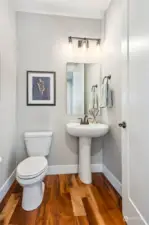 The beautiful timber floors extend into the main floor powder room.