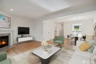 Living room and Dining Room with wood floors & a cozy wood burning fireplace - Virtually staged to give you a sense of the potential! All freshly painted too!