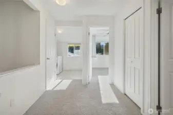 Upper hall with linen closets & pull down ladder to extra storage attic above.