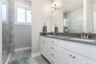 Primary ensuite bathroom with double sinks.