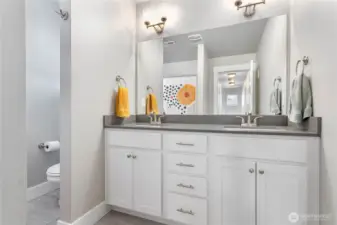 Upstairs full bathroom with double sinks.