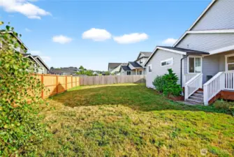 Spacious backyard with covered deck.