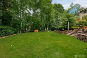 To the left is a custom, black iron fence which appears hidden, giving you the full private "forest" view behind your home. In addition, this fence is well inside your property line. Push it out further and expand the size of your yard from here!