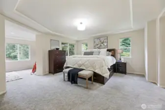 Luxurious primary suite with French doors, sitting room, and private covered deck