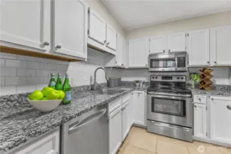 Updated kitchen with granite counters, stainless steel appliances, and subway tile backsplash.