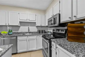 Efficient kitchen layout with ample cabinetry and sleek modern updates.