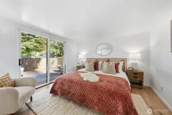 Primary bedroom with sliding glass doors heading to the backyard