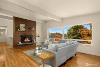 Huge living room with beamed vaulted ceilings and western-facing windows.